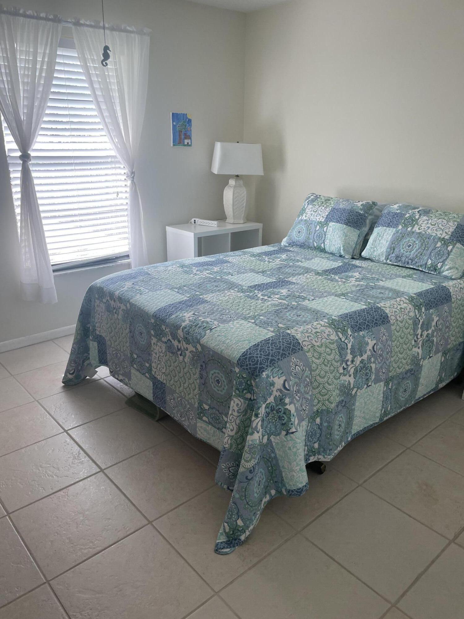 108 Greenbriar Drive Jupiter, FL 33458 - Photo 3 of 8 a bedroom with a bed and window