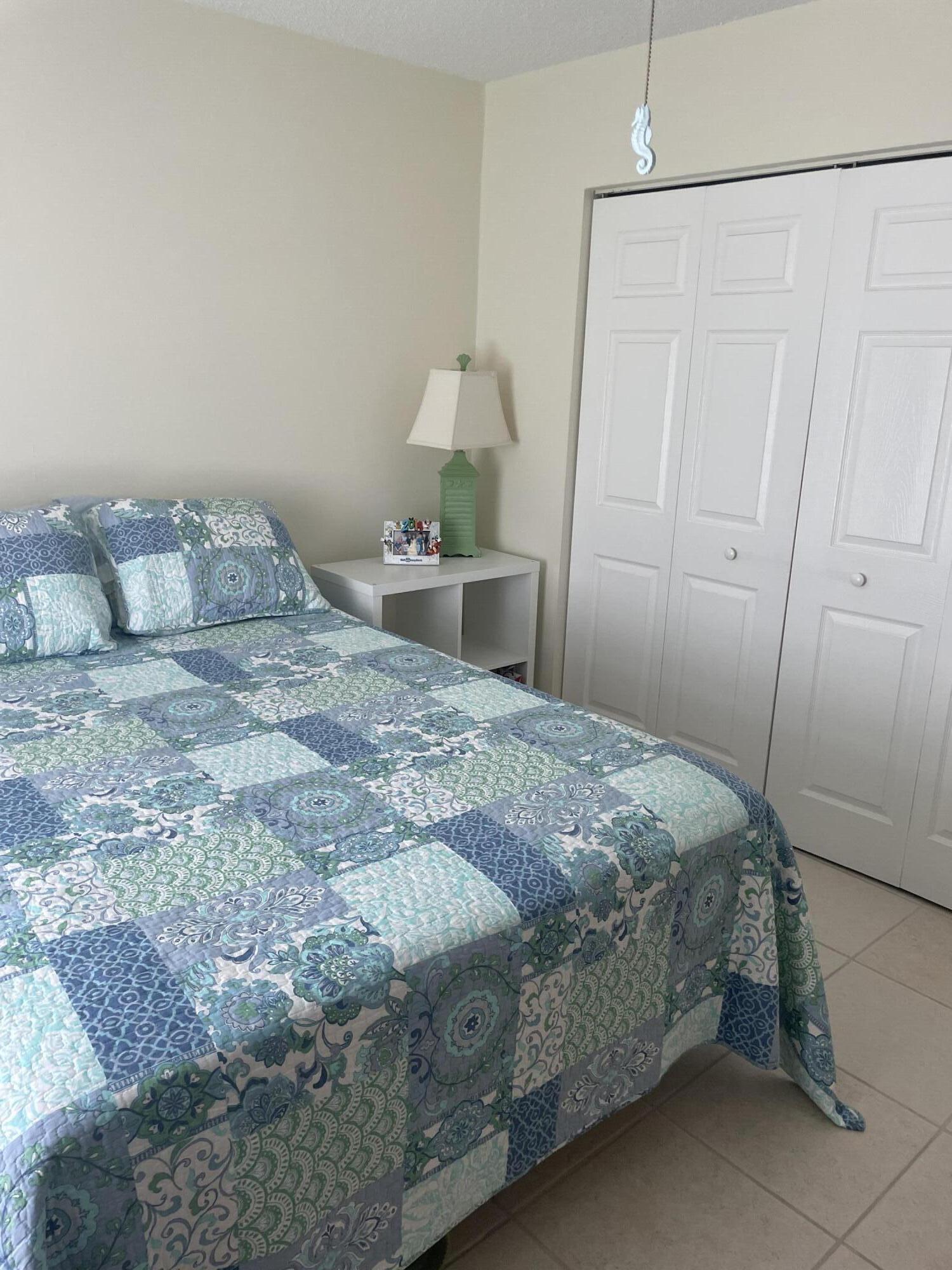 108 Greenbriar Drive Jupiter, FL 33458 - Photo 4 of 8 a bedroom with a bed and a window