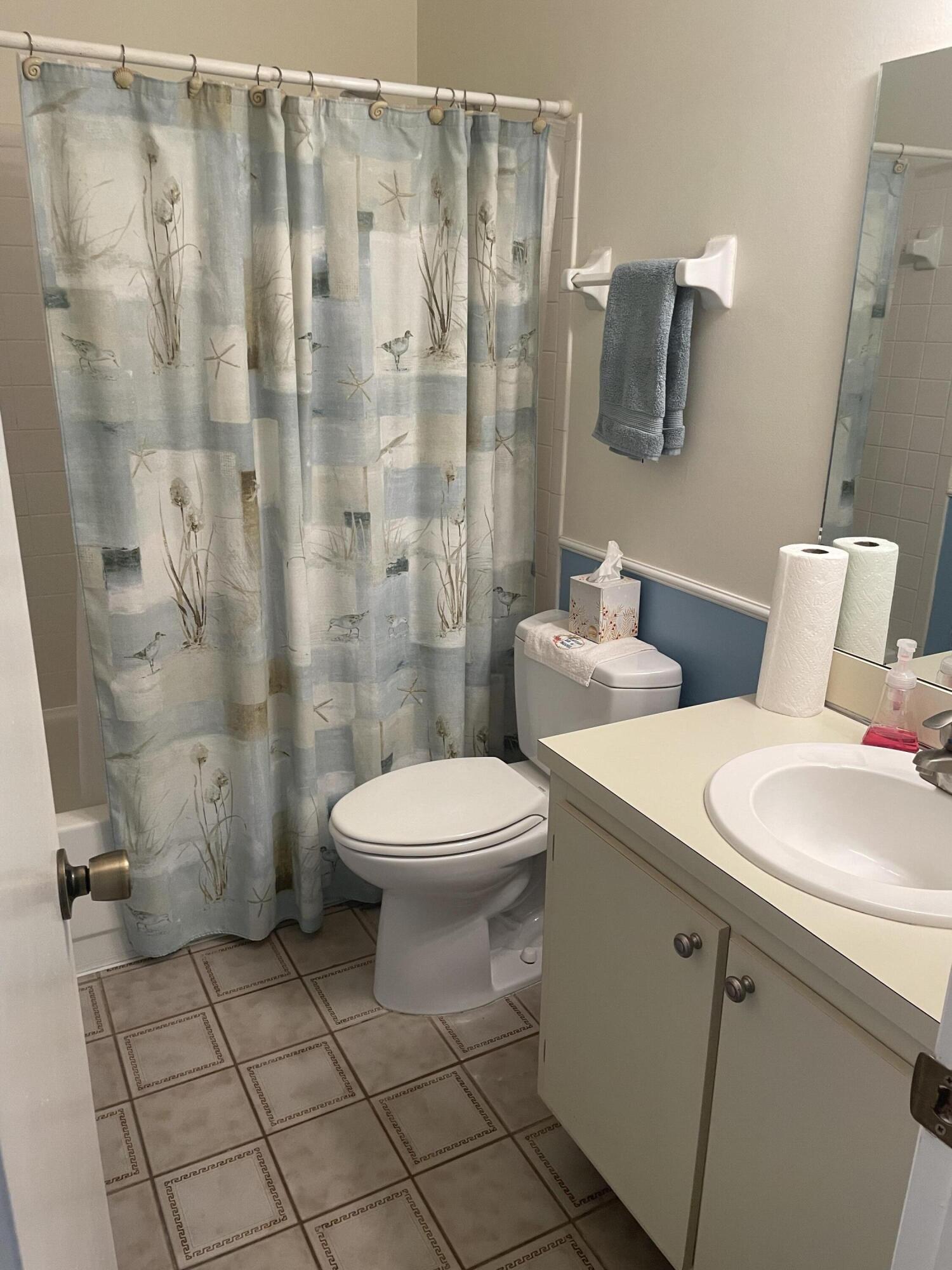 108 Greenbriar Drive Jupiter, FL 33458 - Photo 5 of 8 a bathroom with a toilet sink and shower