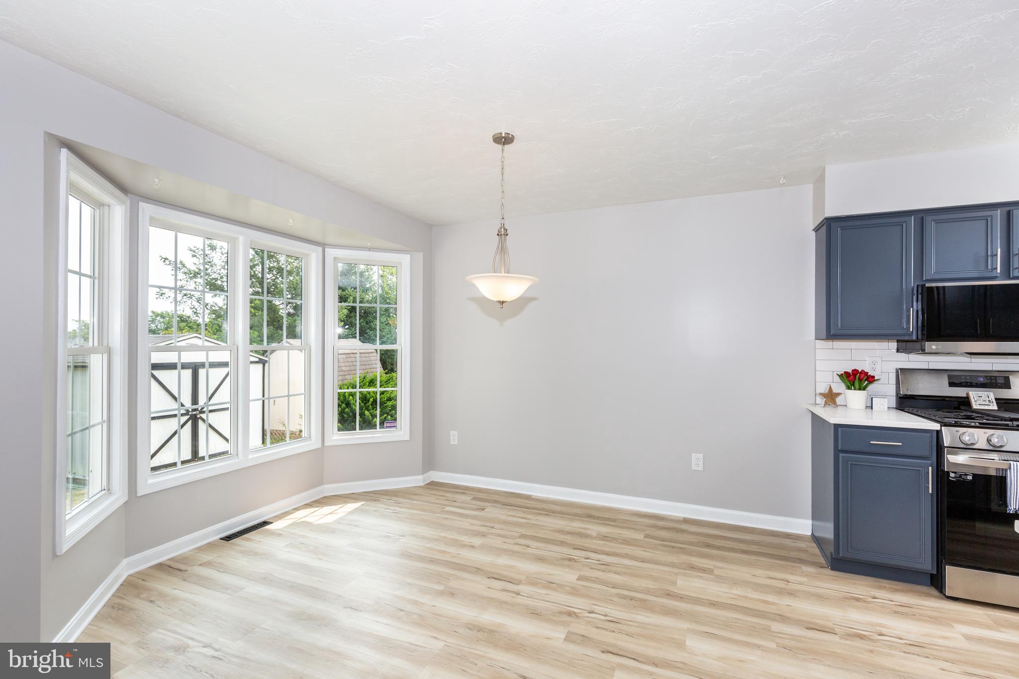 159 Colorado Avenue Littlestown, PA 17340 - Photo 13 of 47 a view of a kitchen with a stove wooden floor and a window