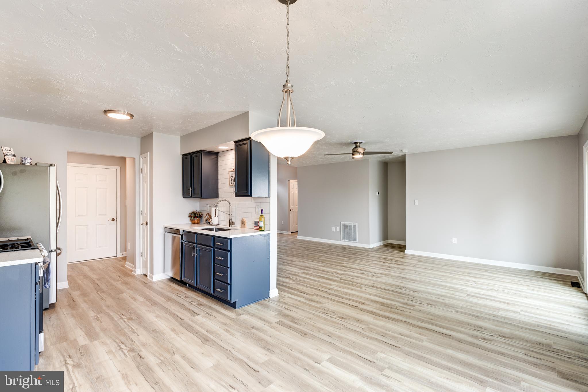 159 Colorado Avenue Littlestown, PA 17340 - Photo 15 of 47 a kitchen with stainless steel appliances granite countertop a sink a stove and a wooden floors
