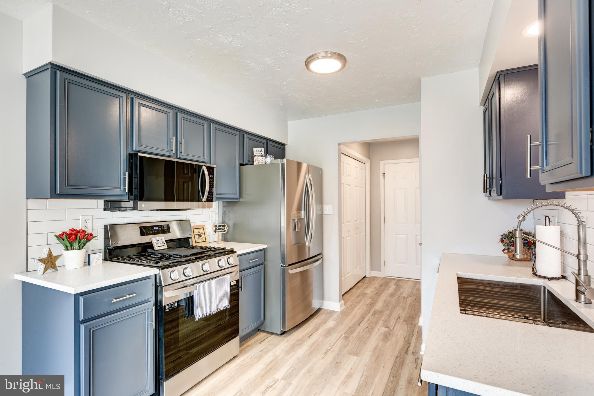 159 Colorado Avenue Littlestown, PA 17340 - Photo 17 of 47 a kitchen with stainless steel appliances a refrigerator stove and microwave