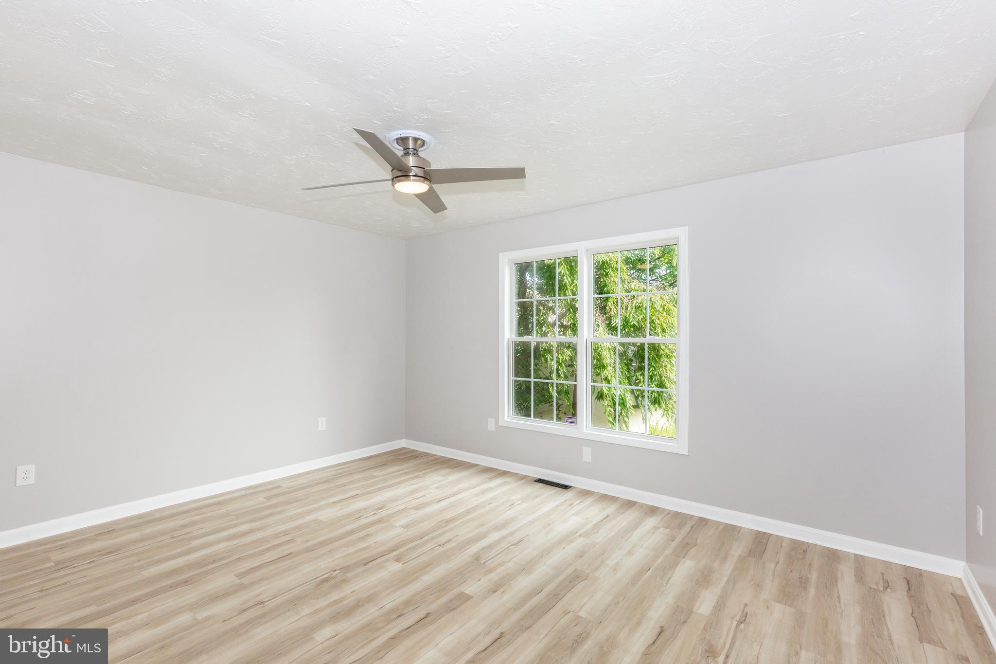 159 Colorado Avenue Littlestown, PA 17340 - Photo 22 of 47 an empty room with wooden floor and windows