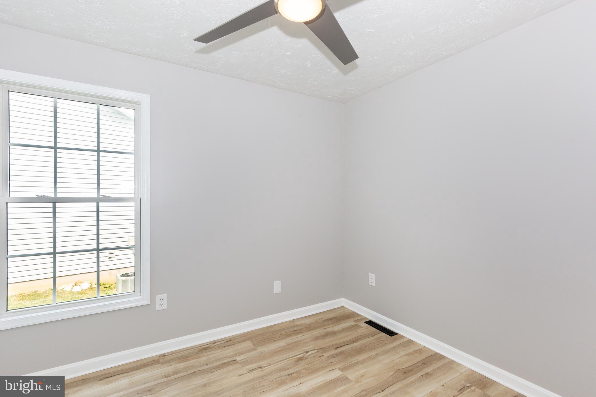 159 Colorado Avenue Littlestown, PA 17340 - Photo 32 of 47 an empty room with a window and wooden floor