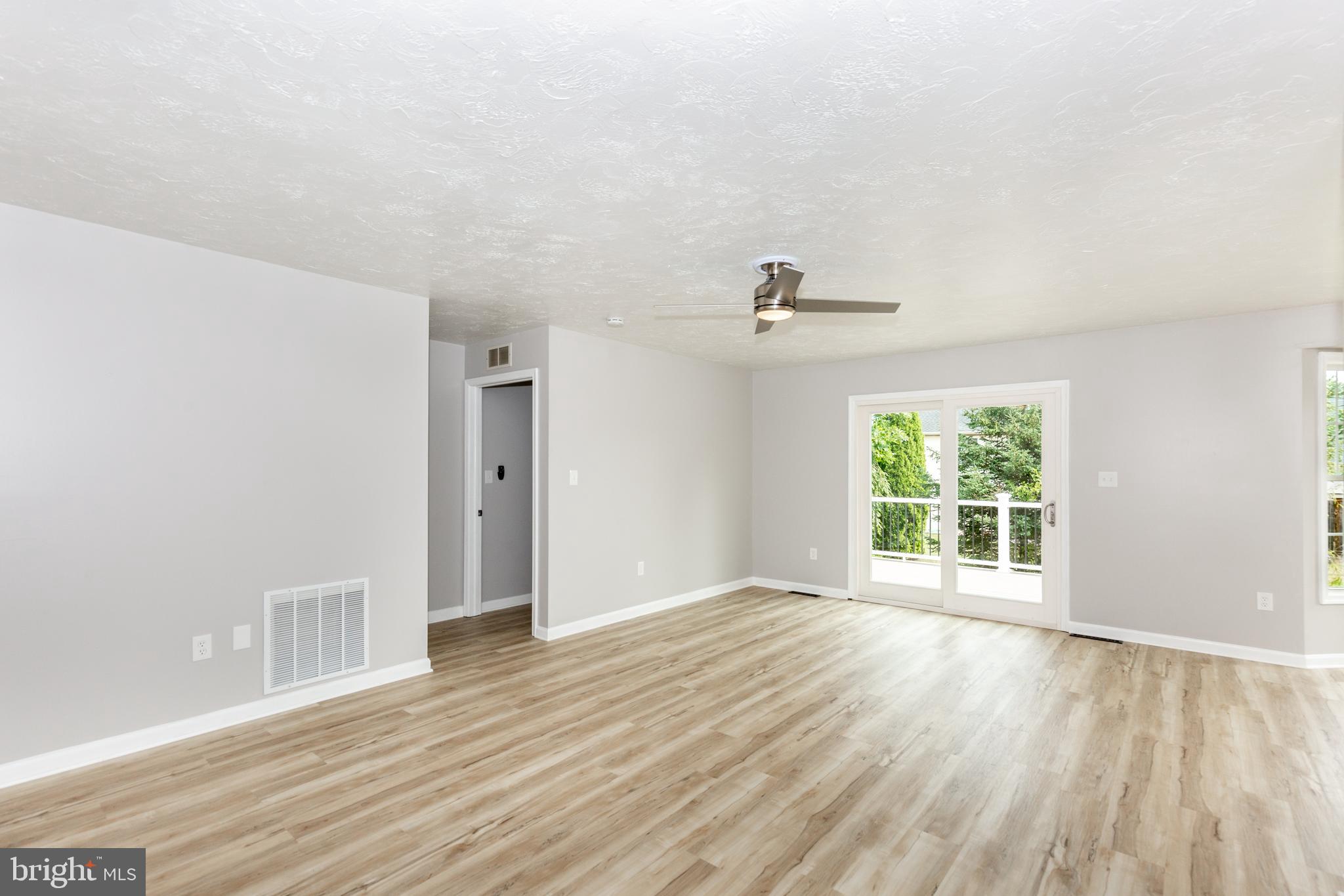 159 Colorado Avenue Littlestown, PA 17340 - Photo 9 of 47 a view of an empty room with wooden floor and a window