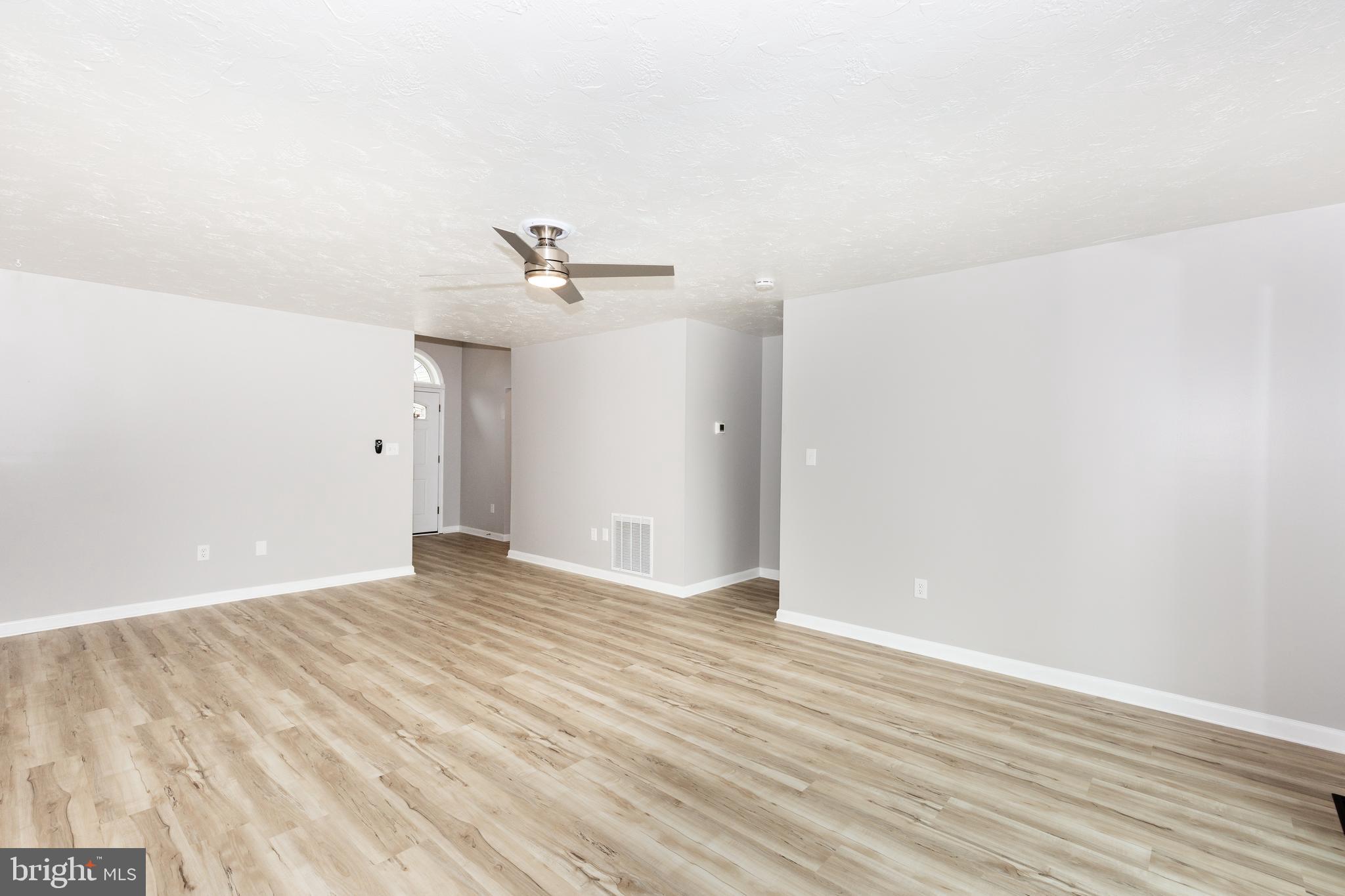 159 Colorado Avenue Littlestown, PA 17340 - Photo 10 of 47 a view of an empty room with wooden floor
