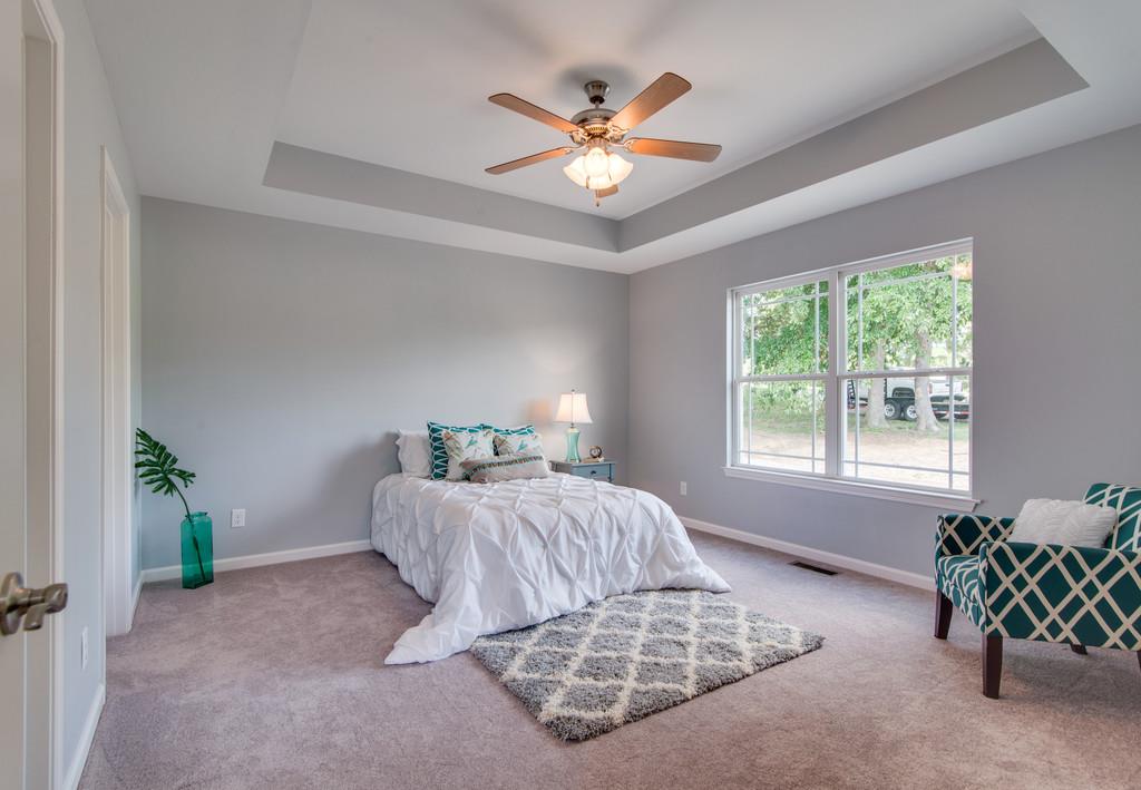 1016 Glendale Road Dickson, TN 37055 - Photo 8 of 28 a bedroom with a bed and a chandelier