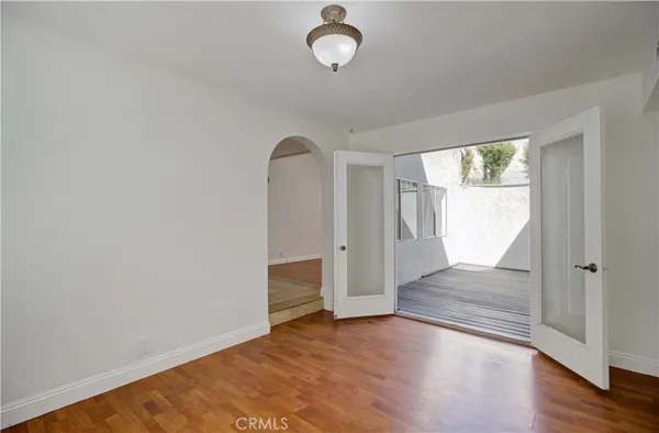 a view of empty room with wooden floor and fireplace