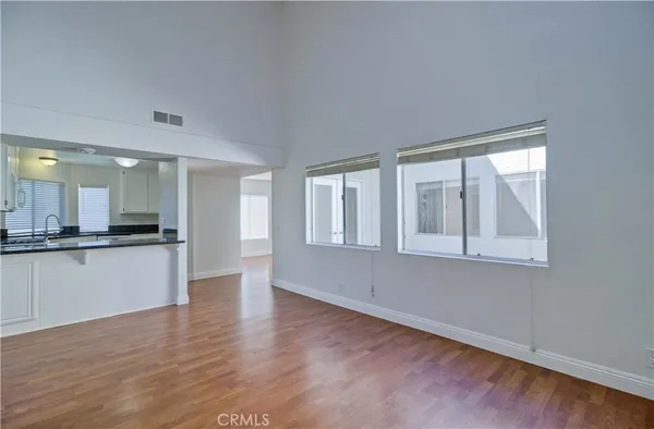 a view of kitchen with wooden floor and electronic appliances