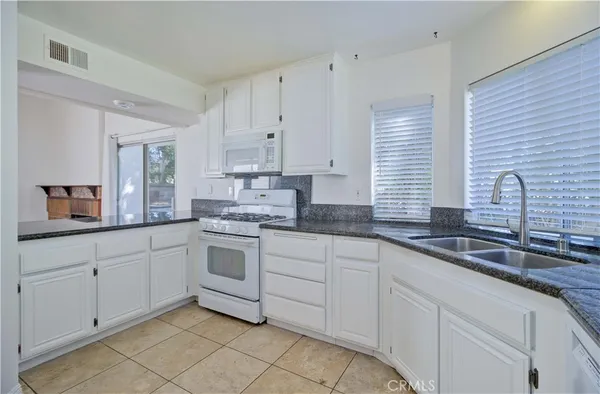 a kitchen with white cabinets and a sink