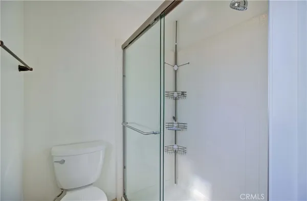 a bathroom with a toilet and a shower