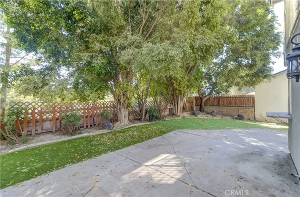 a view of a backyard with a garden and trees