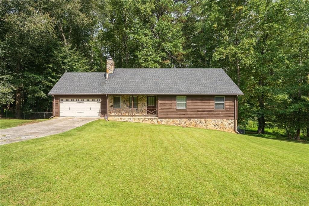 5935 Catawba Way Atlanta, GA 30349 - Photo 1 of 1 a aerial view of a house with swimming pool next to a yard