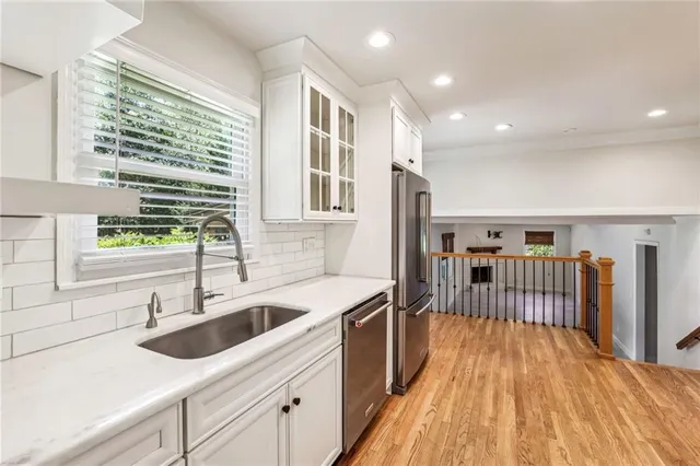a kitchen with a sink a counter top space and stainless steel appliances
