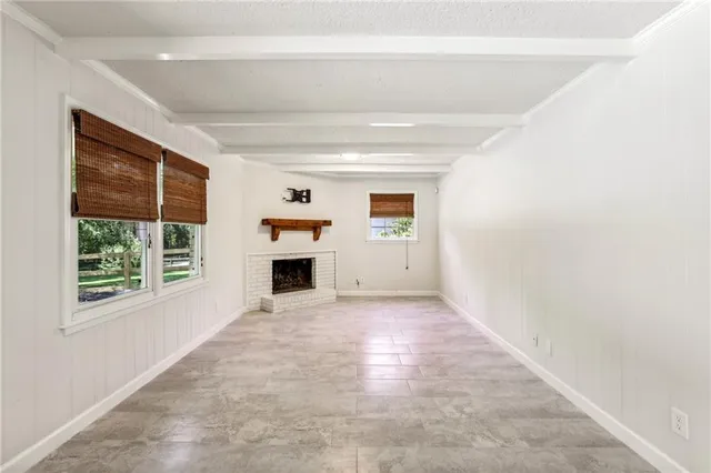 a view of a livingroom with an empty space and a fireplace