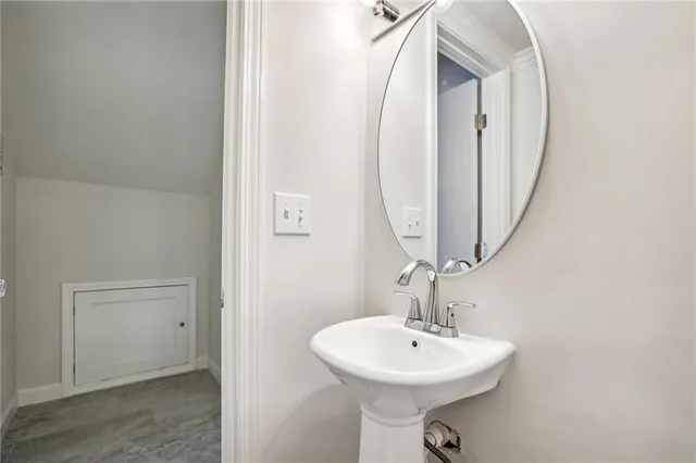 a bathroom with a sink a mirror and bathtub