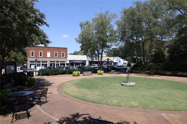 a wooden bench sitting in front of building
