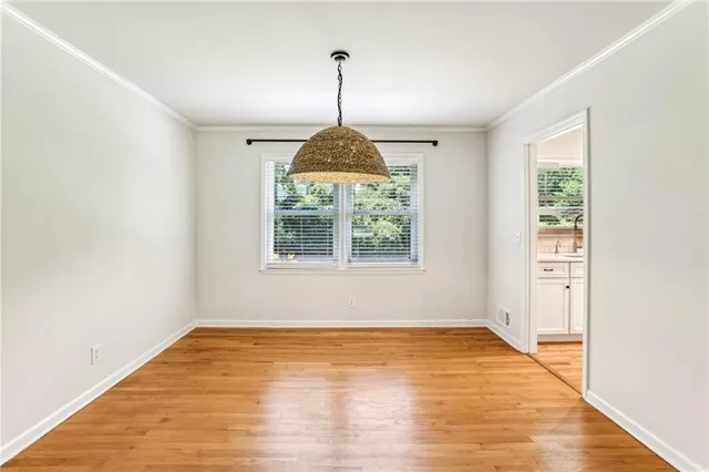 a view of a room window and wooden floor