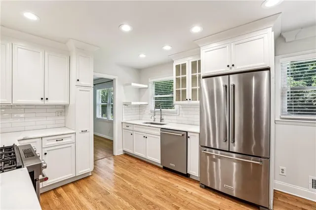 a kitchen with stainless steel appliances a refrigerator sink and microwave