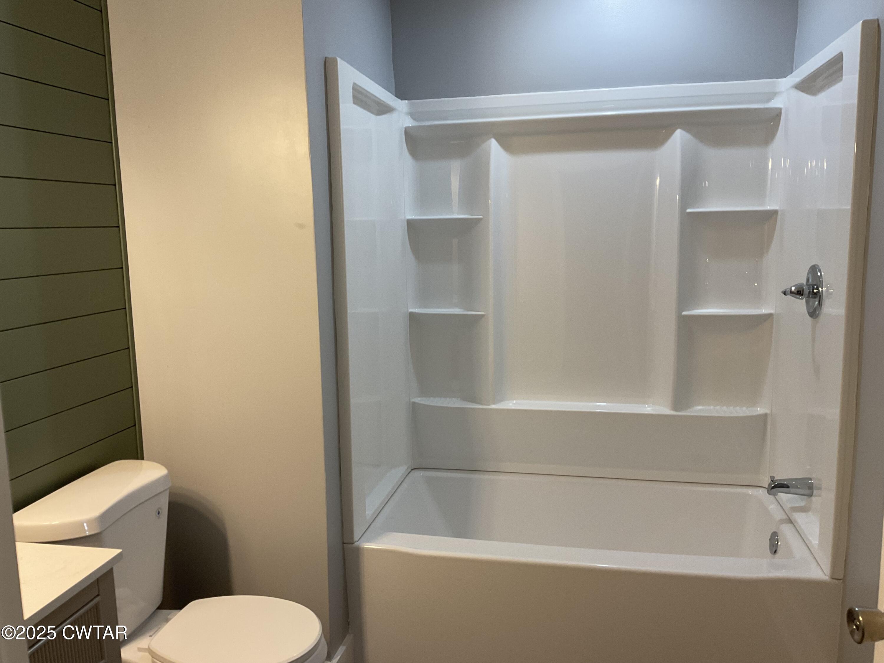 306 Mobile Street Jackson, TN 38301 - Photo 7 of 10 a white bath tub sitting next to a white toilet