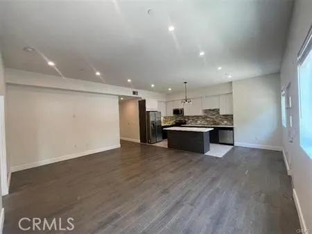 a view of kitchen with kitchen island and stainless steel appliances