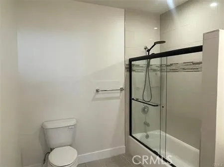 a bathroom with a shower toilet and sink