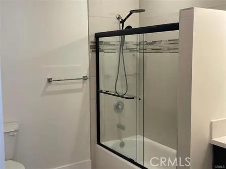 a bathroom with a glass shower door