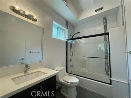 a bathroom with a sink mirror toilet and shower