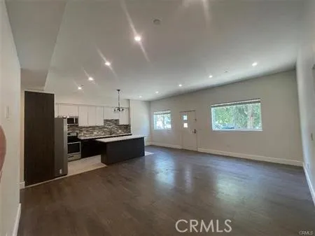 a large hall with stainless steel appliances granite countertop a large counter top
