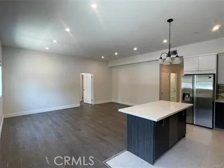 a kitchen with kitchen island a counter top space appliances and cabinets
