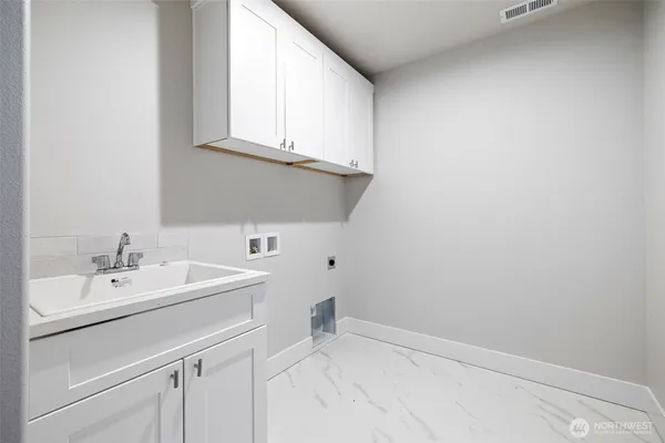 a bathroom with a sink and a white cabinet