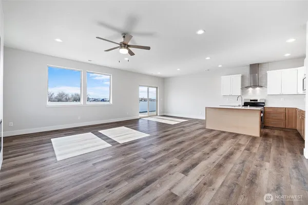 a view of empty room with wooden floor and window