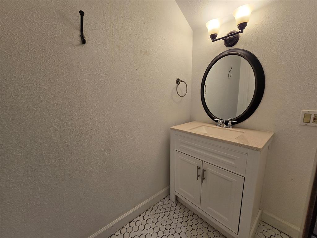 3741 Hilltop Road Fort Worth, TX 76109 - Photo 24 of 35 Upstairs, Hall Bathroom with a storage vanity and decorative lighting.
