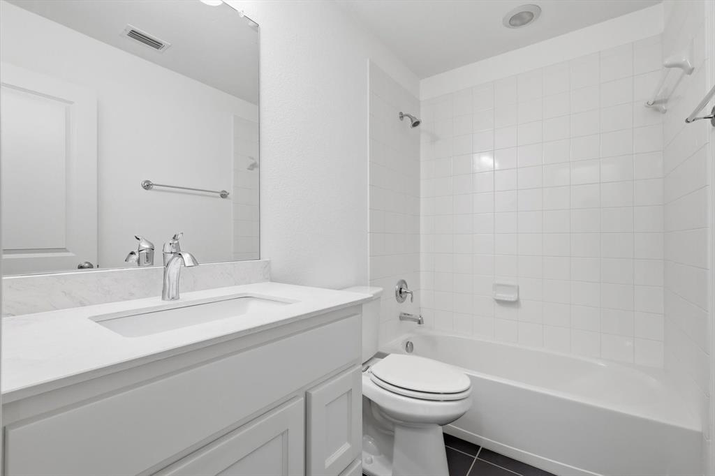 228 Skystone Drive Irving, TX 75038 - Photo 21 of 28 a bathroom with a sink a toilet and shower