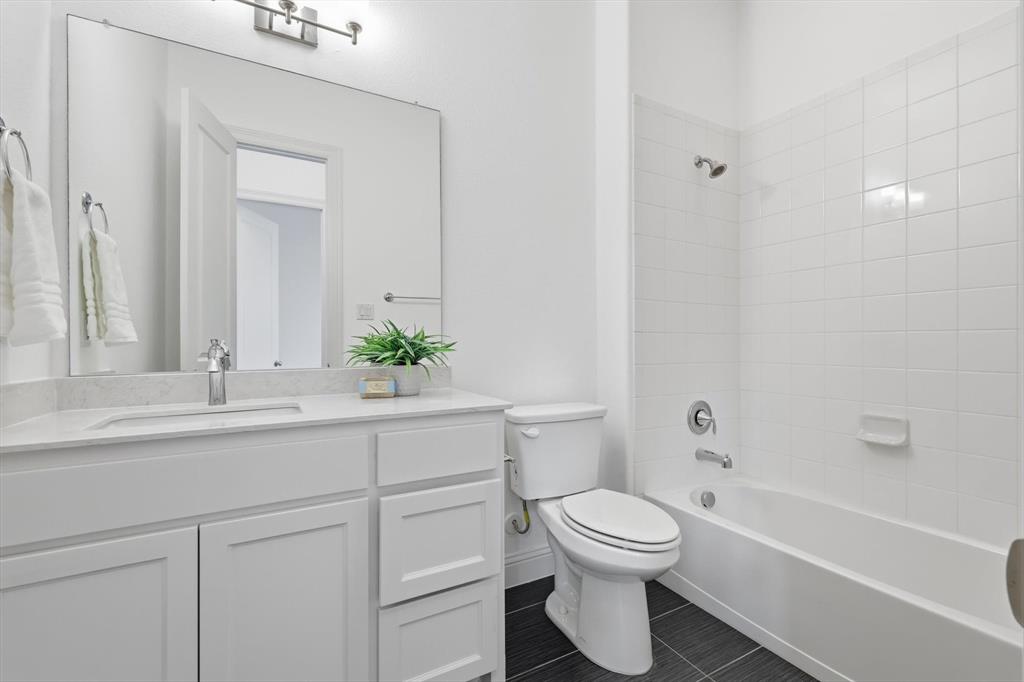 228 Skystone Drive Irving, TX 75038 - Photo 23 of 28 a bathroom with a sink a toilet and a bathtub