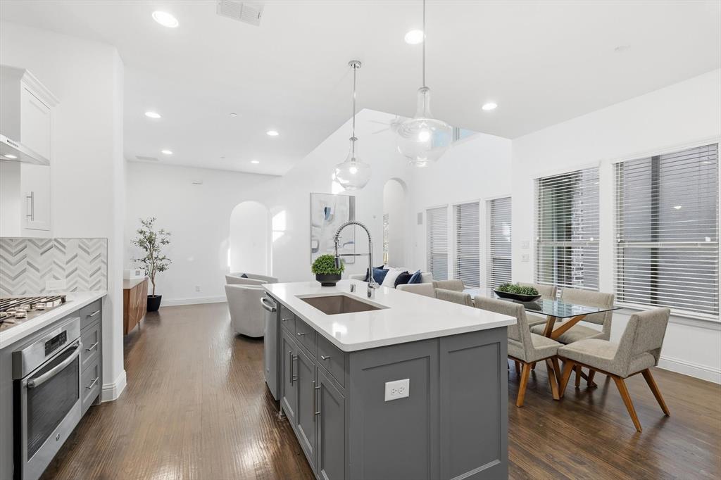 228 Skystone Drive Irving, TX 75038 - Photo 10 of 28 a open kitchen with a sink a stove and chairs