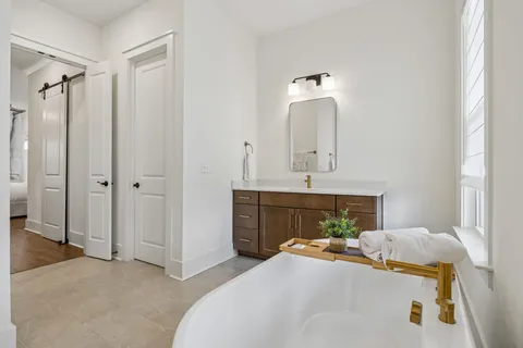 a bedroom with a bed and a mirror