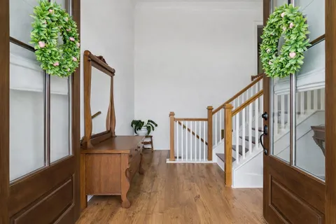 wooden floor in a room with a potted plant
