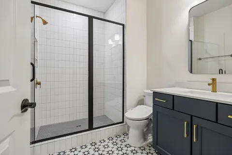a bathroom with a shower toilet and sink