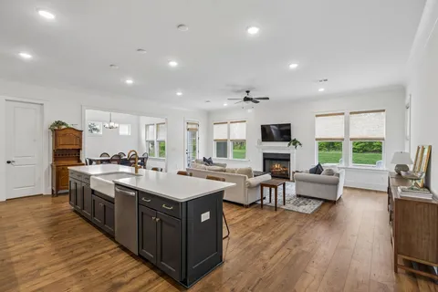 a large kitchen with stainless steel appliances a large center island and a stove