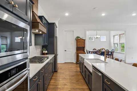 a kitchen with stainless steel appliances a sink and a refrigerator