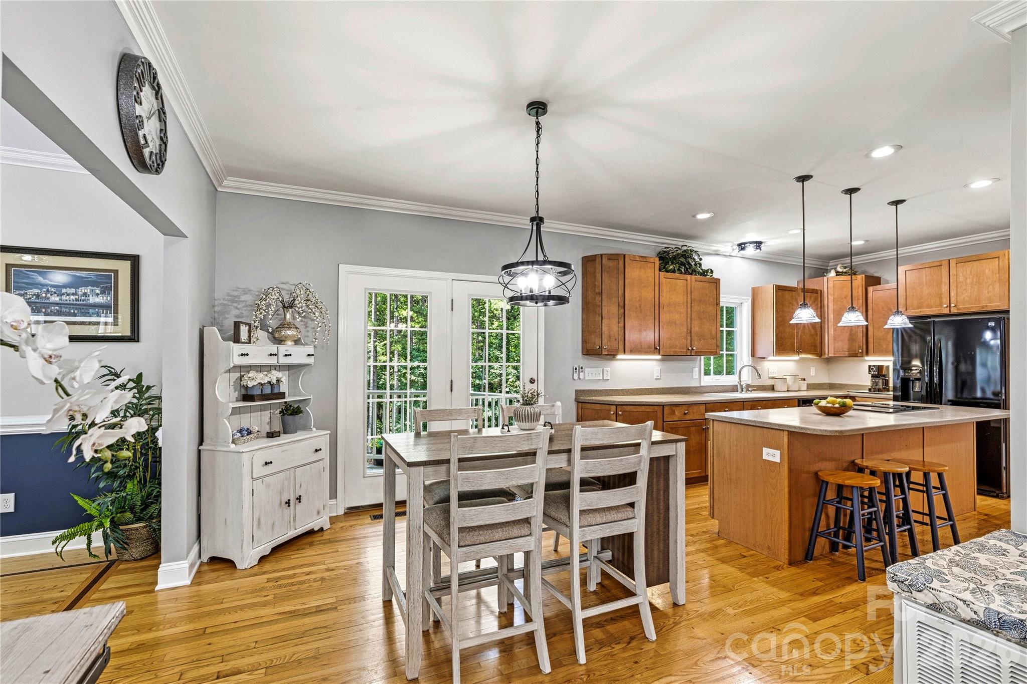 1606 High Ridge Drive Stanley, NC 28164 - Photo 6 of 44 a kitchen with stainless steel appliances granite countertop a stove top oven a sink a dining table and chairs with wooden floor