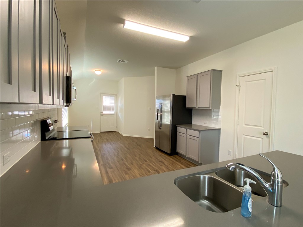 301 Greatest Gift Way Jarrell, TX 76537 - Photo 7 of 20 a view of a kitchen with a sink and dishwasher
