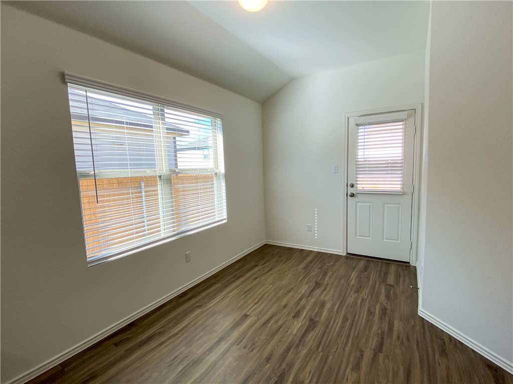 301 Greatest Gift Way Jarrell, TX 76537 - Photo 10 of 20 a view of an empty room with wooden floor and a window