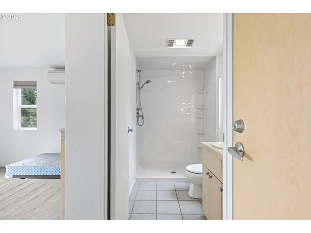 a bedroom with a large bed and a large window