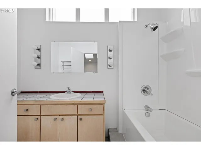 a view of a yard with plants and a bench