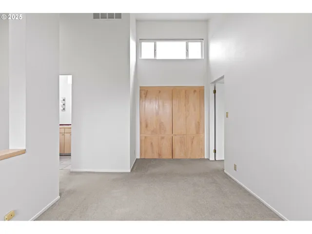 a bathroom with a sink a mirror a toilet and a window