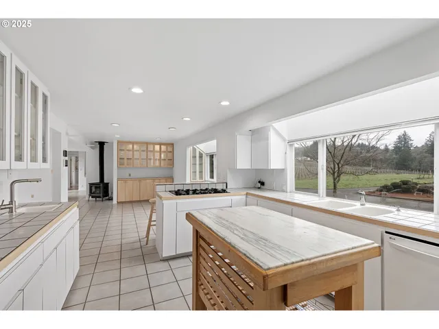 a open kitchen with a sink and cabinets