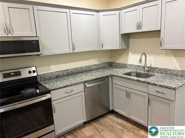 a white toilet sitting next to a bathroom sink and a tub