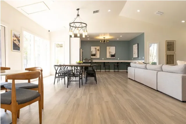 a living room with furniture and kitchen view